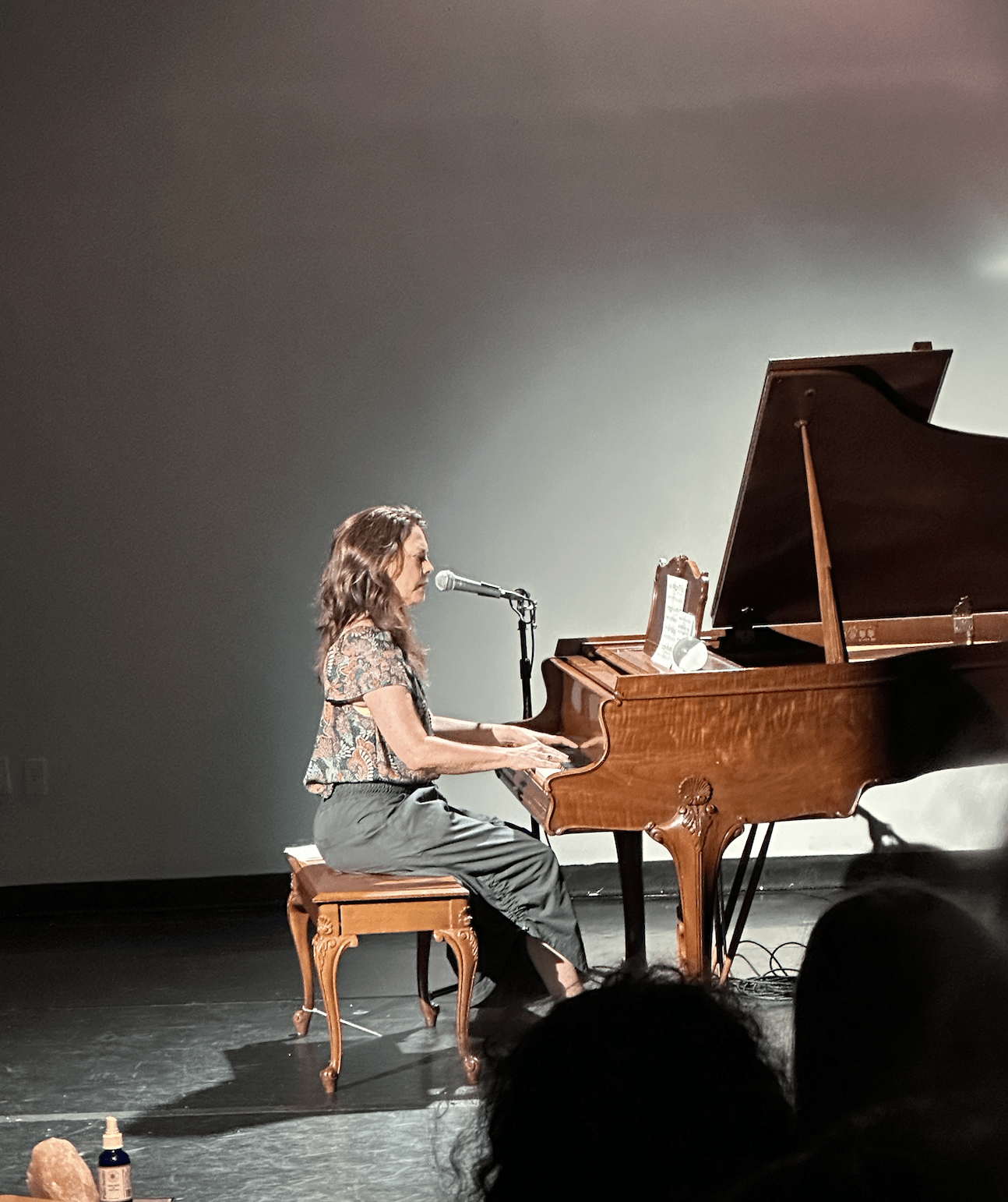 Leah playing the piano on stage